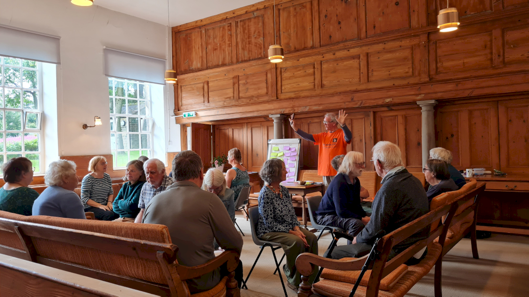 Facilitator speaking to a group of people at a workshop